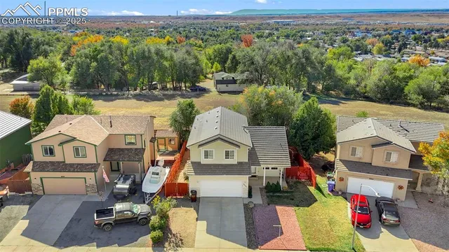 an aerial view of a houses with a swimming pool