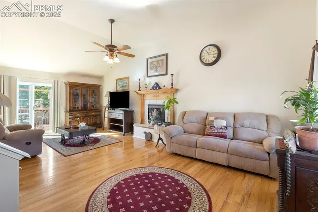 a living room with furniture a fireplace and a flat screen tv