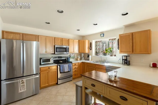 a kitchen with granite countertop stainless steel appliances and sink