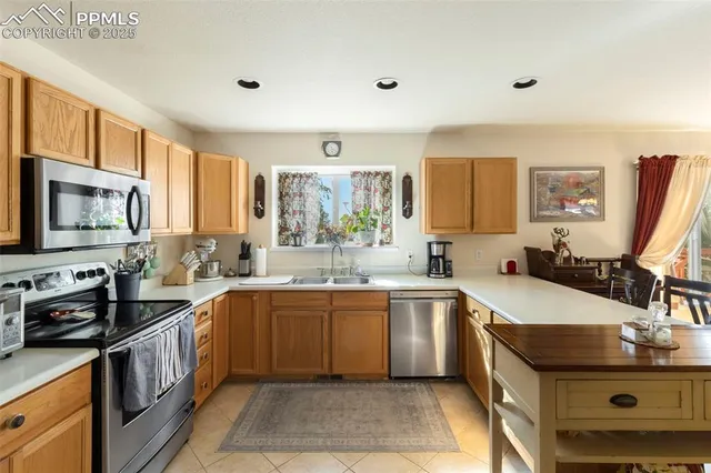 a kitchen with a sink stove top oven and microwave