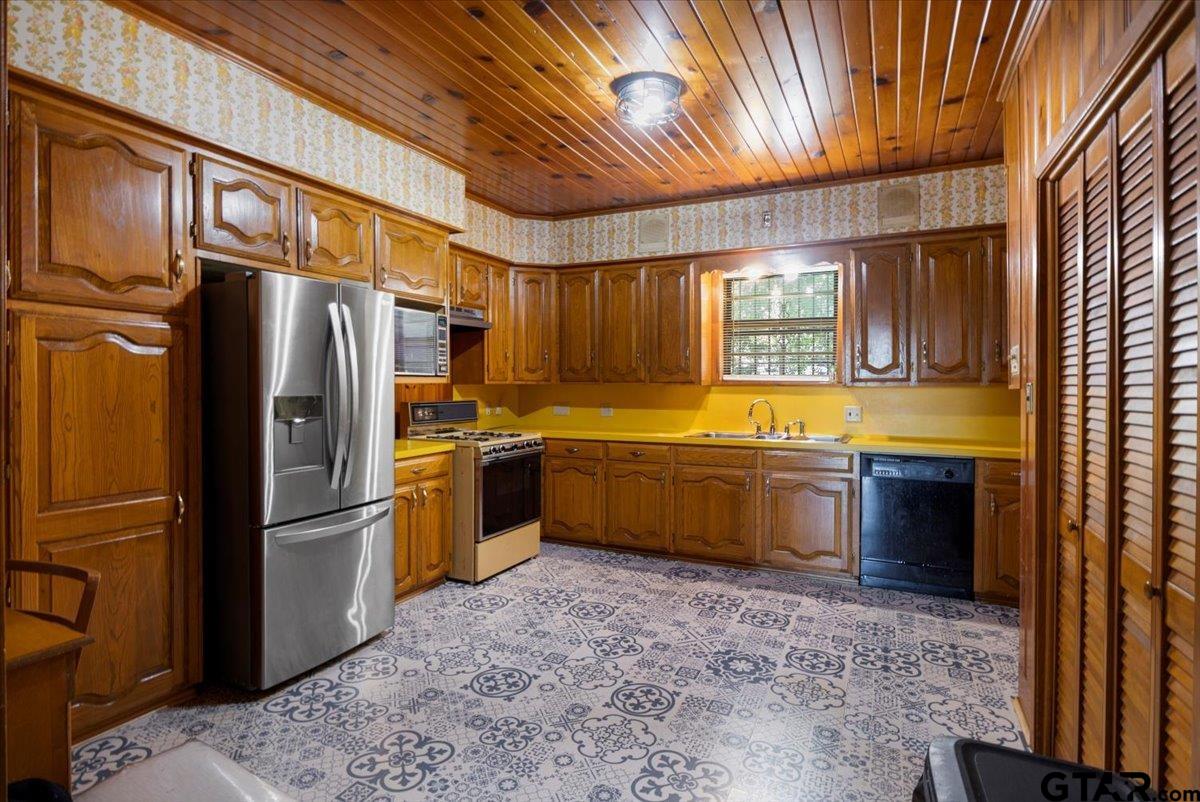 3109 West Shaw Street Tyler, TX 75701 - Photo 11 of 27 a kitchen with stainless steel appliances granite countertop a refrigerator a sink a stove and dishwasher