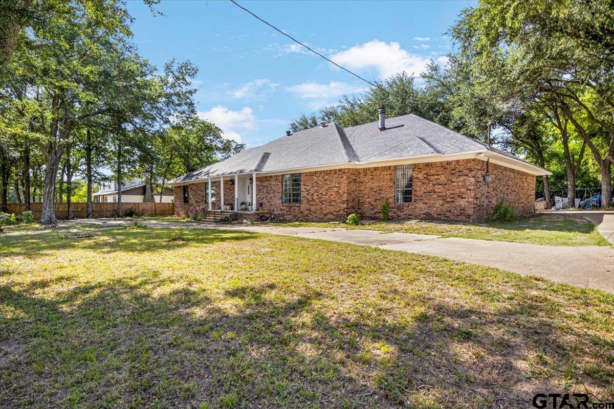 3109 West Shaw Street Tyler, TX 75701 - Photo 3 of 27 a house view with a swimming pool next to a big yard