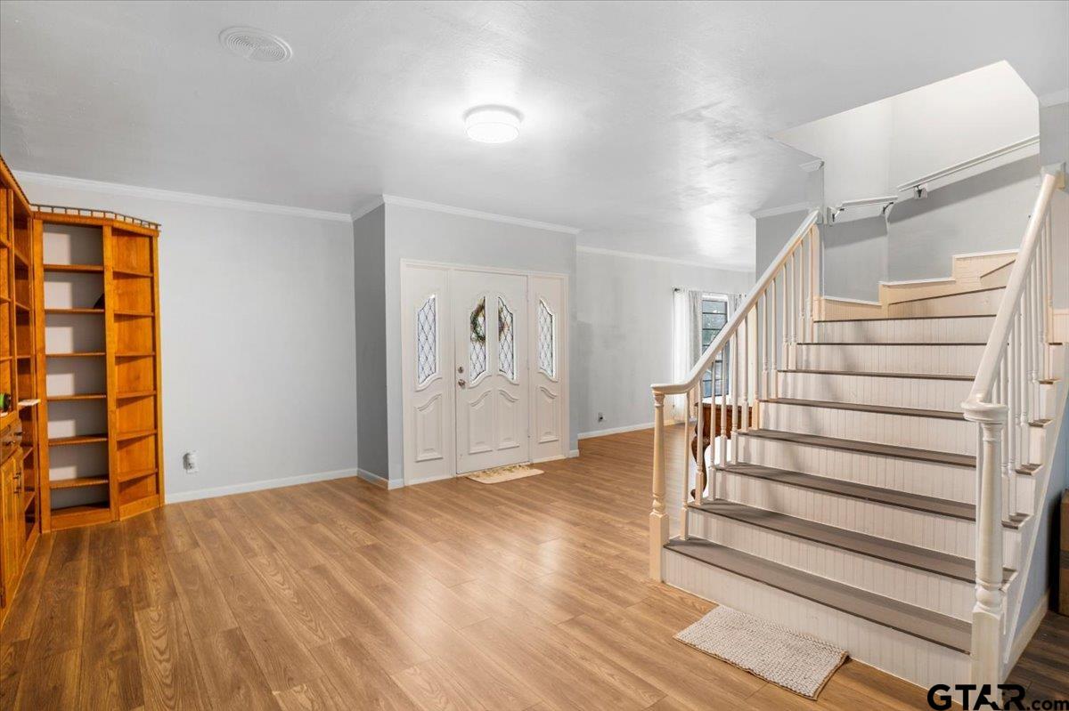 3109 West Shaw Street Tyler, TX 75701 - Photo 5 of 27 a view of entryway with stairs and wooden floor