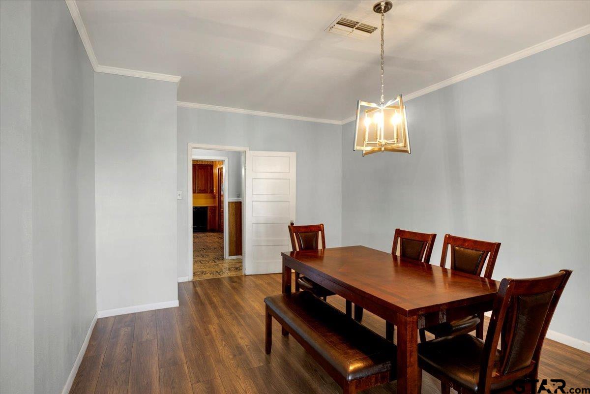 3109 West Shaw Street Tyler, TX 75701 - Photo 7 of 27 a view of a dining room with furniture and wooden floor