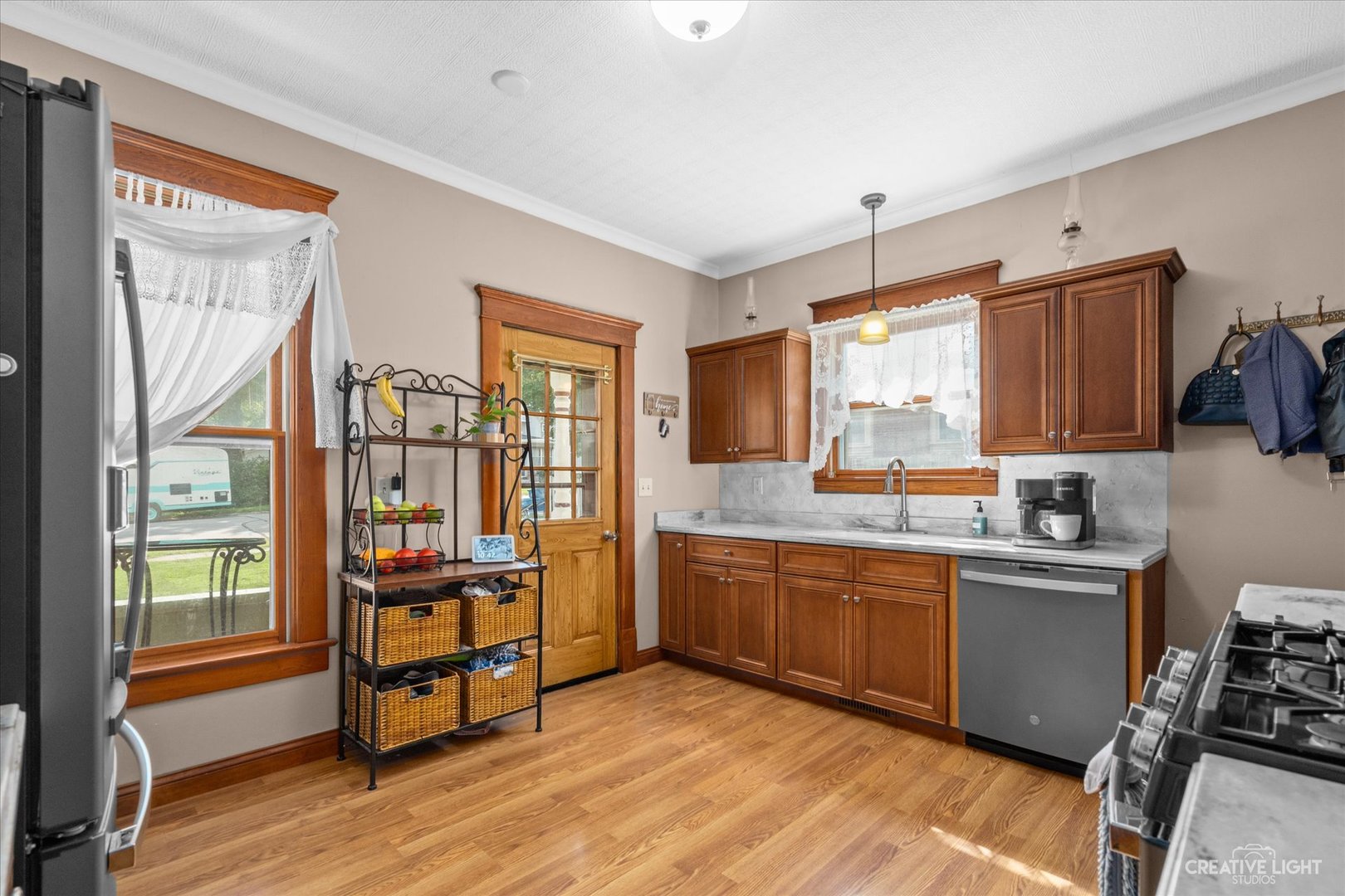 322 East 3rd Street Dixon, IL 61021 - Photo 13 of 30 a kitchen with stainless steel appliances granite countertop a stove and a refrigerator