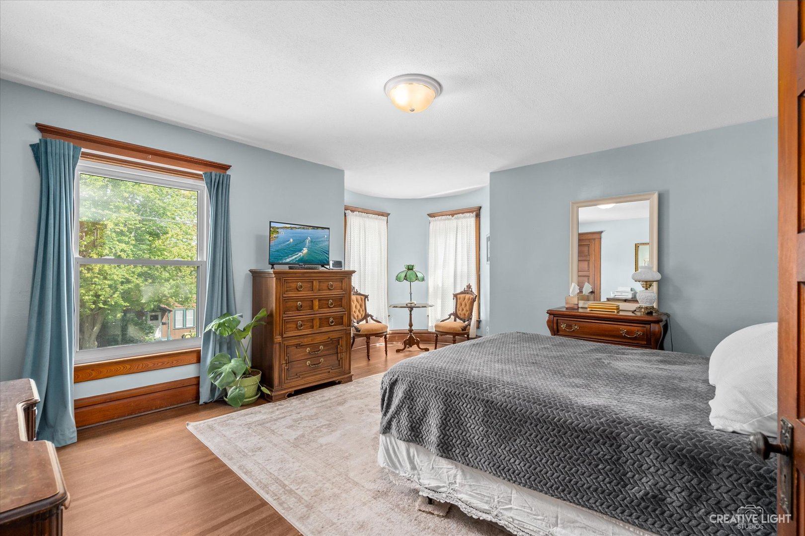 322 East 3rd Street Dixon, IL 61021 - Photo 17 of 30 a bedroom with a bed and wooden floor