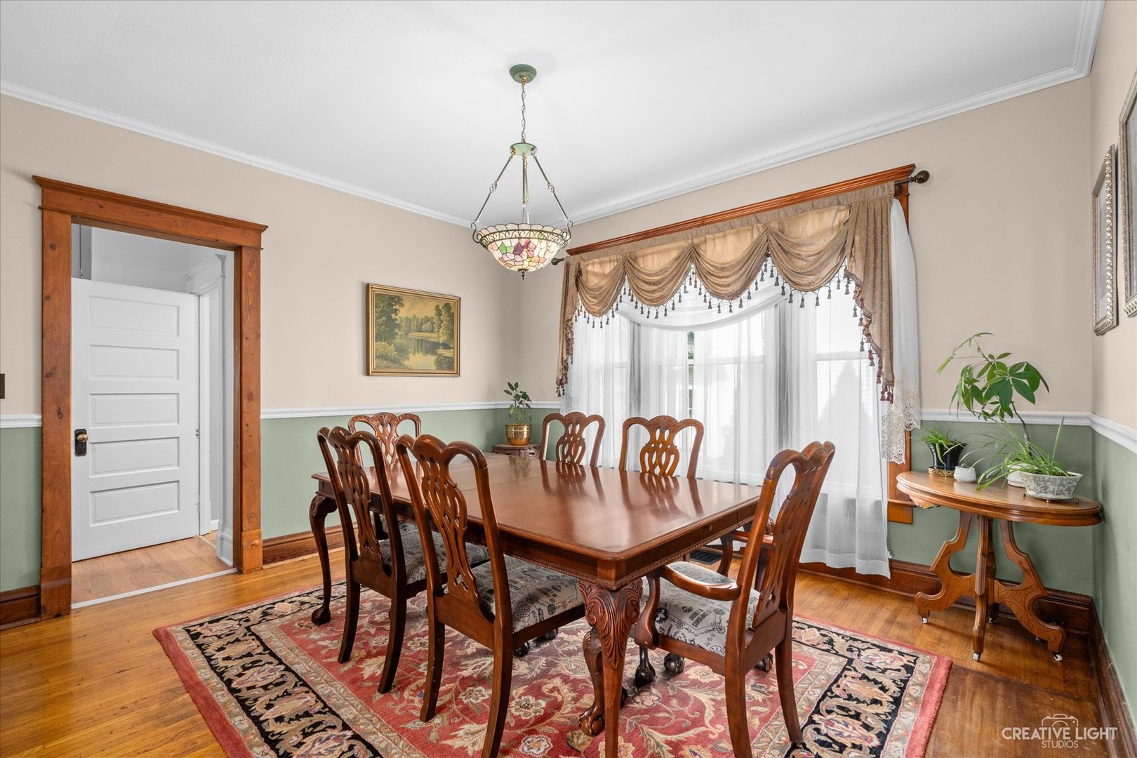 322 East 3rd Street Dixon, IL 61021 - Photo 9 of 30 a dining room with furniture a chandelier and wooden floor