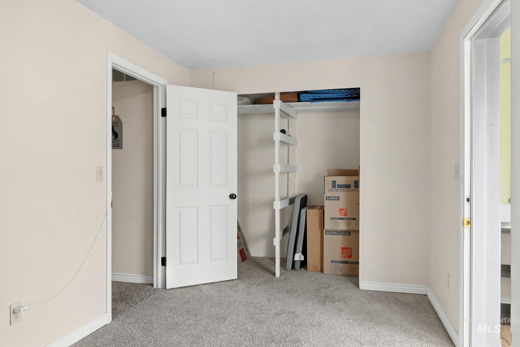 18338 Pride Lane Caldwell, ID 83607 - Photo 31 of 50 Carpeted room featuring a closet with bi-fold doors and built-in shelving