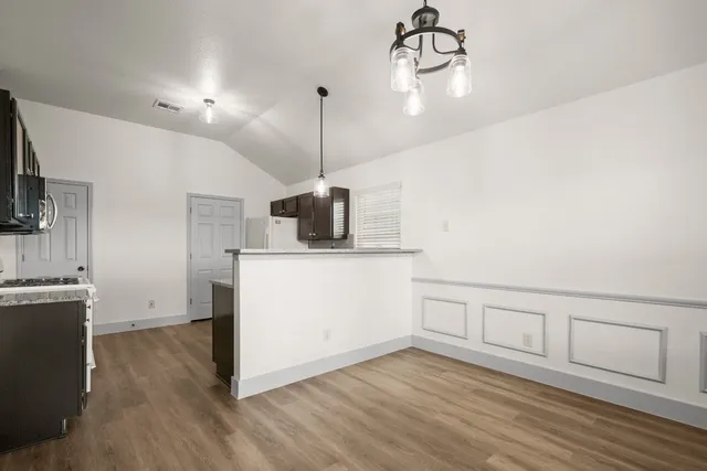 a view of a kitchen with a sink wooden floor and staircase