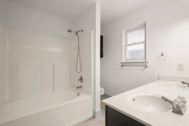 a bathroom with a bathtub and a sink