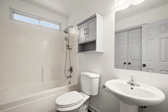 a bathroom with a sink toilet and shower