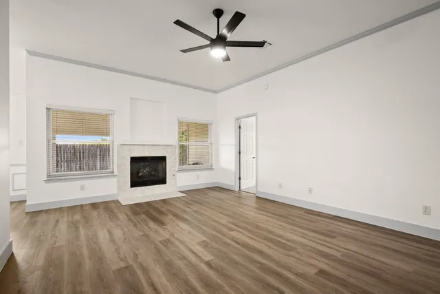 wooden floor in an empty room with a fireplace