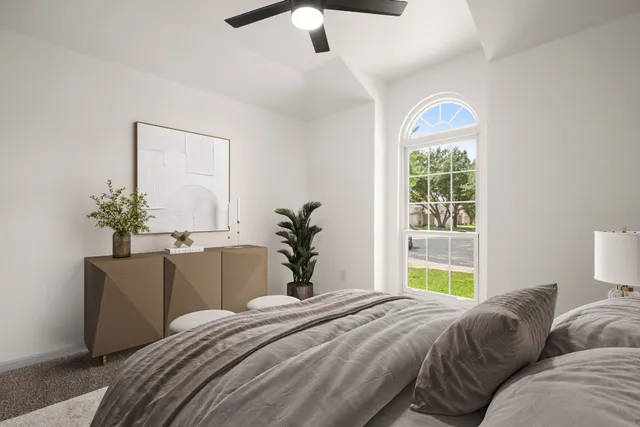 a bedroom with a bed and a potted plant