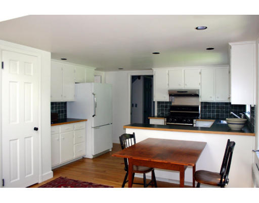 17 Parmenter Road Wayland, MA 01778 - Photo 5 of 18 a room with furniture a flat screen tv and kitchen view