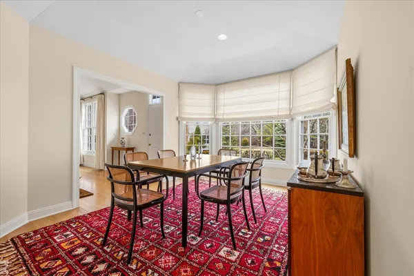 a view of a dining room with furniture large windows and wooden floor