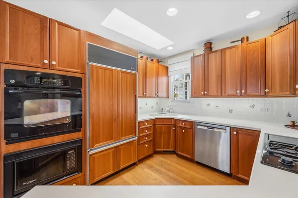 a kitchen with stainless steel appliances granite countertop a refrigerator and a stove top oven