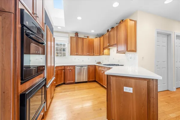 a kitchen with stainless steel appliances granite countertop a stove a sink and a refrigerator