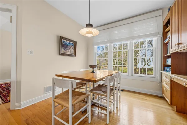 a view of a dining room with furniture a chandelier and wooden floor