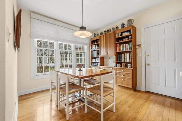 a view of a dining room with furniture wooden floor and chandelier