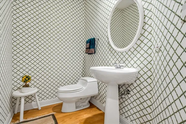 a bathroom with a sink toilet and a mirror