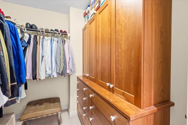 a view of walk in closet with clothes