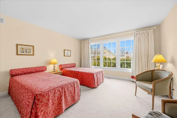 a spacious bathroom with a double vanity sink and mirror