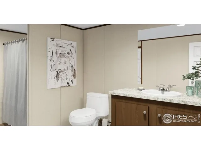 a bathroom with a sink a mirror and a painting on the wall
