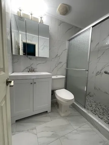 a bathroom with a shower and toilet