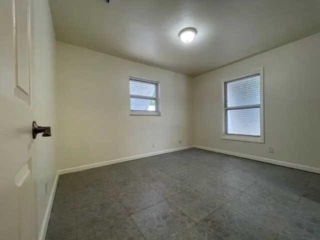 an empty room with a empty space and windows