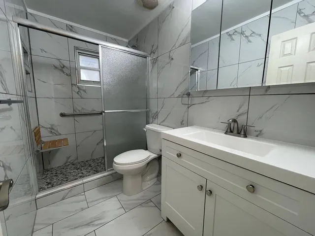 a bathroom with a sink toilet and shower