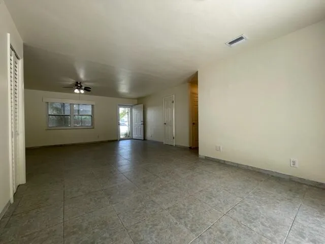 a view of a livingroom with an empty space and a window