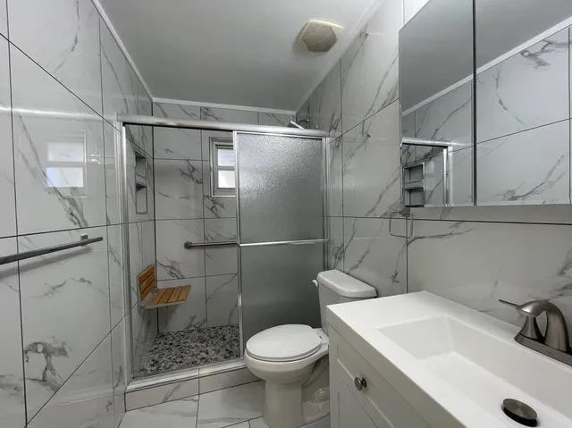 a bathroom with a toilet and a shower