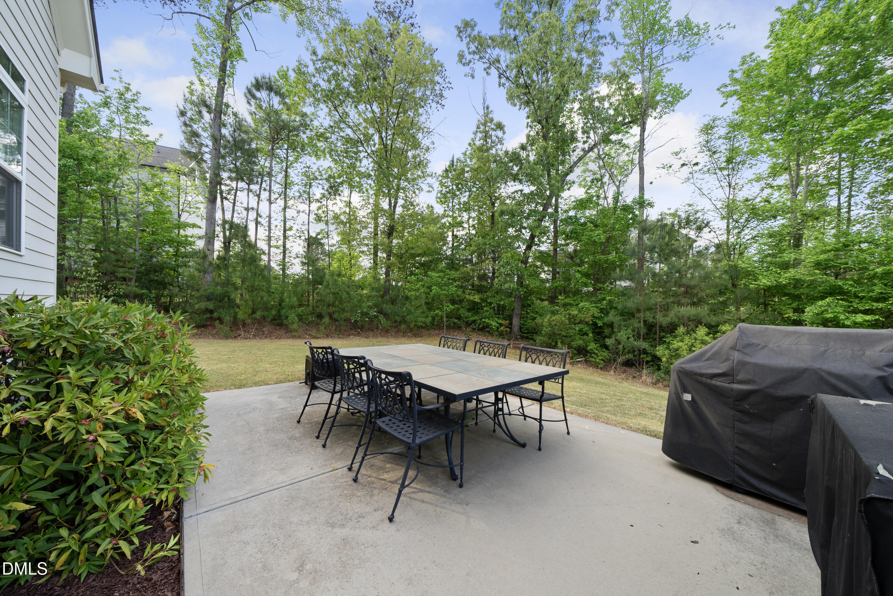 5109 Wainscott Way Raleigh, NC 27612 - Photo 40 of 52 a patio with a table and chairs and potted plants