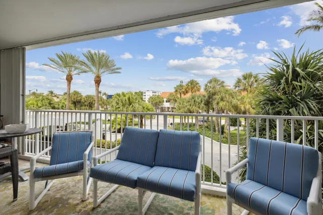 a balcony with wooden floor and outdoor seating