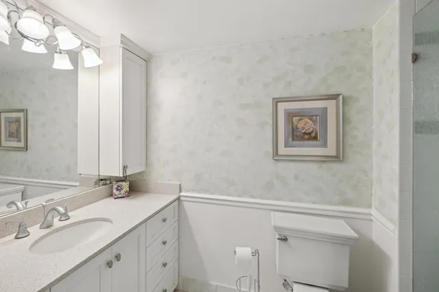 a bathroom with a granite countertop sink mirror and vanity