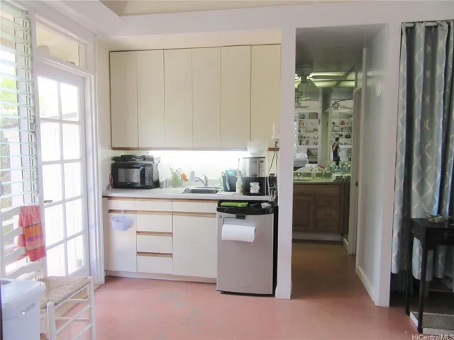 a kitchen with stainless steel appliances a refrigerator sink and cabinets