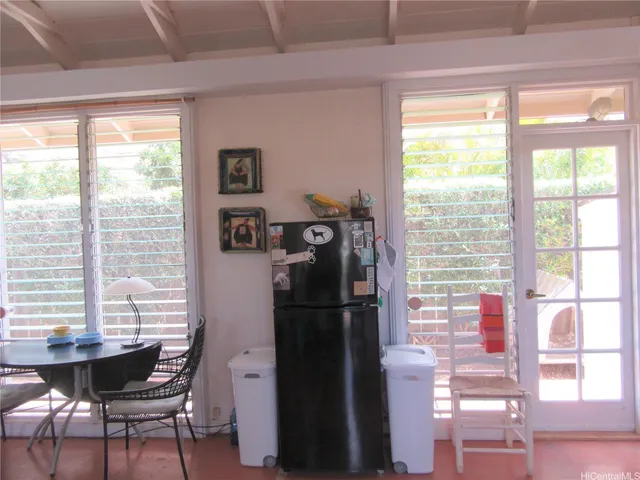 a view of a dining room with furniture and a window