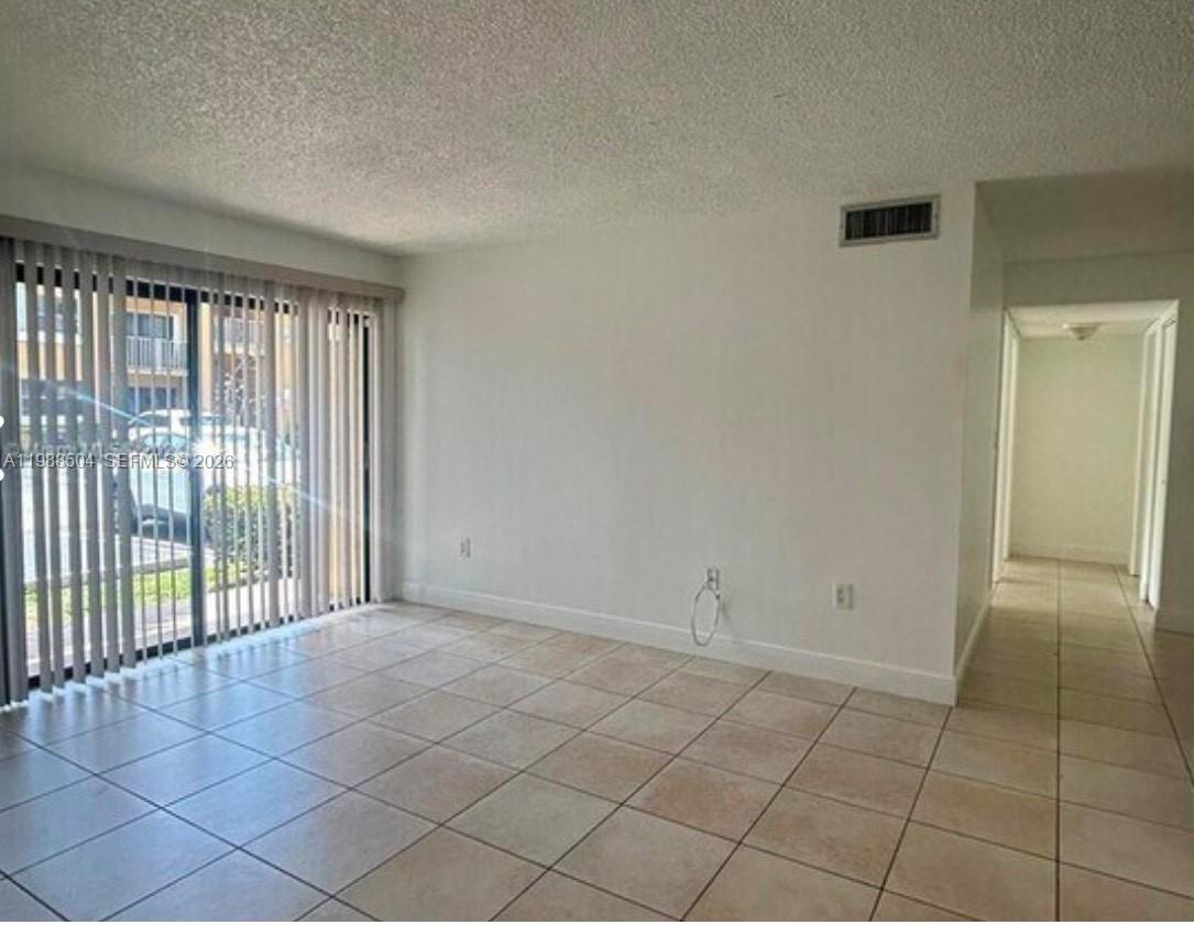 15520 Southwest 80th Street, Unit B103 Miami, FL 33193 - Photo 3 of 7 a view of an empty room and window