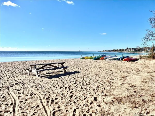 a kitchen with granite countertop a sink stove and refrigerator