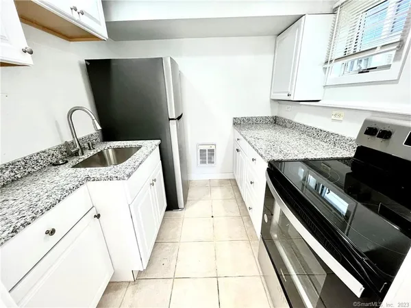 a view of a livingroom with an empty space and a window