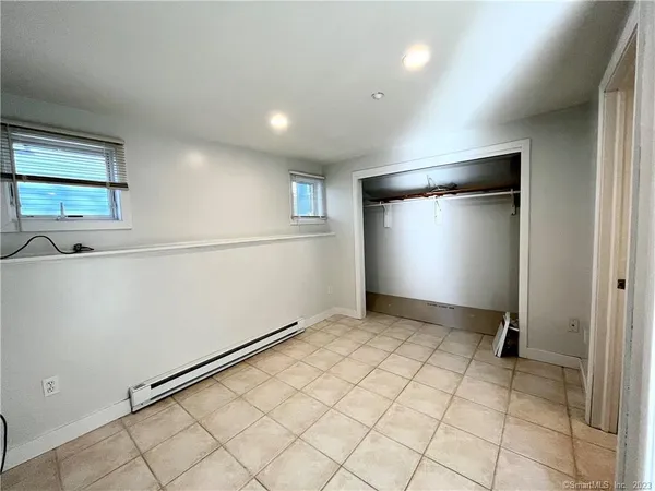 a bathroom with a granite countertop sink toilet a mirror and shower
