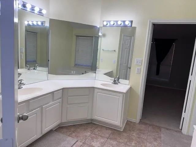 a bathroom with a double vanity sink and mirror