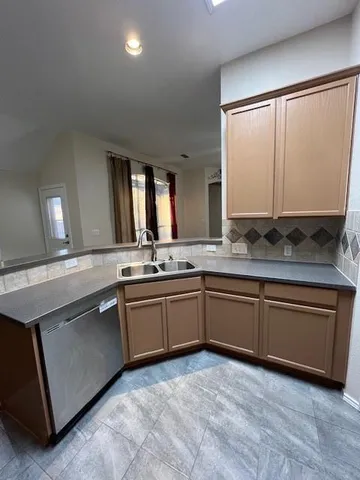 a spacious bathroom with a granite countertop sink and a mirror