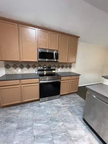 a kitchen with a sink stove and microwave