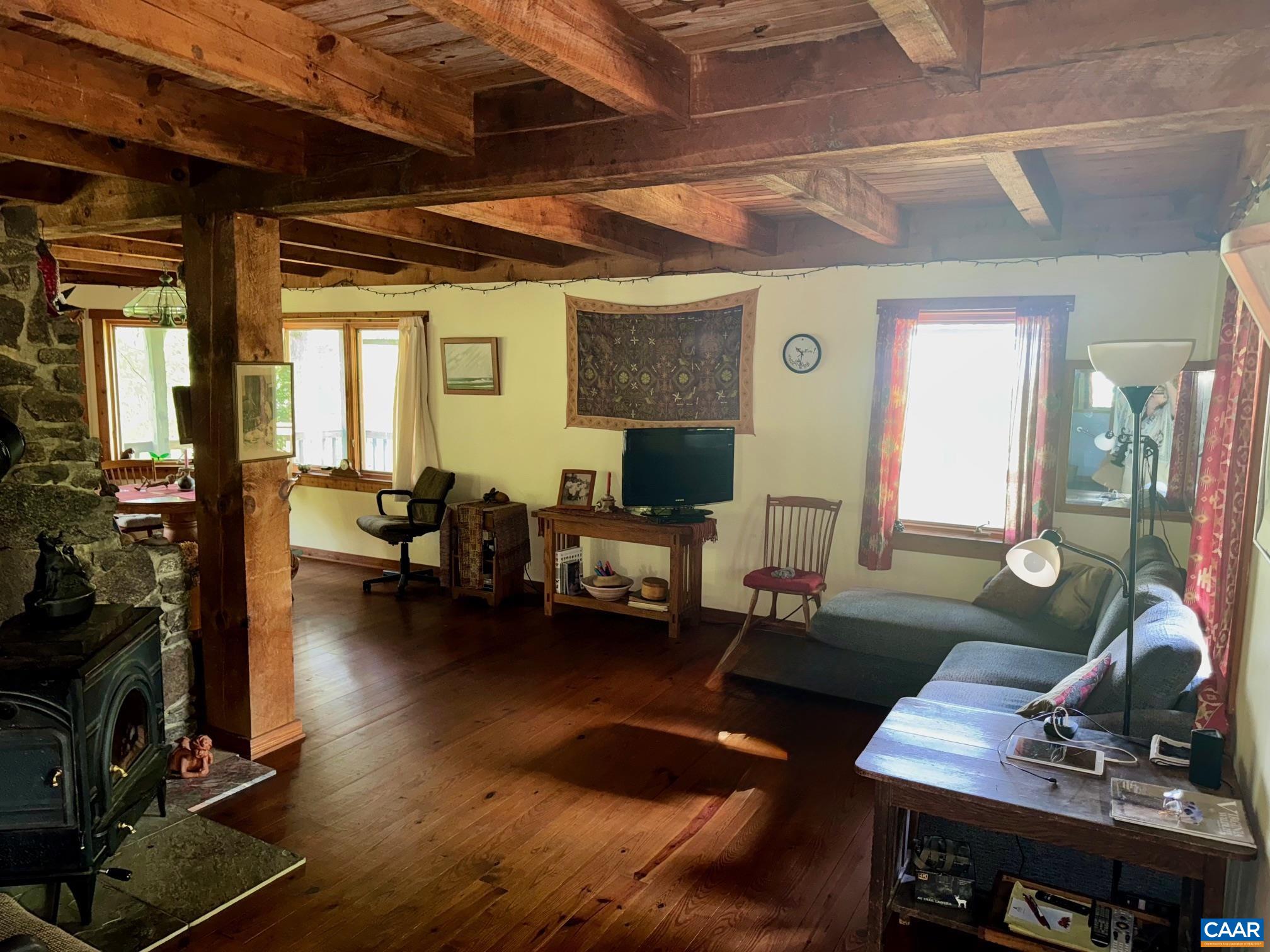 1950 Locust Hollow Road Charlottesville, VA 22903 - Photo 24 of 54 a living room with furniture and a flat screen tv