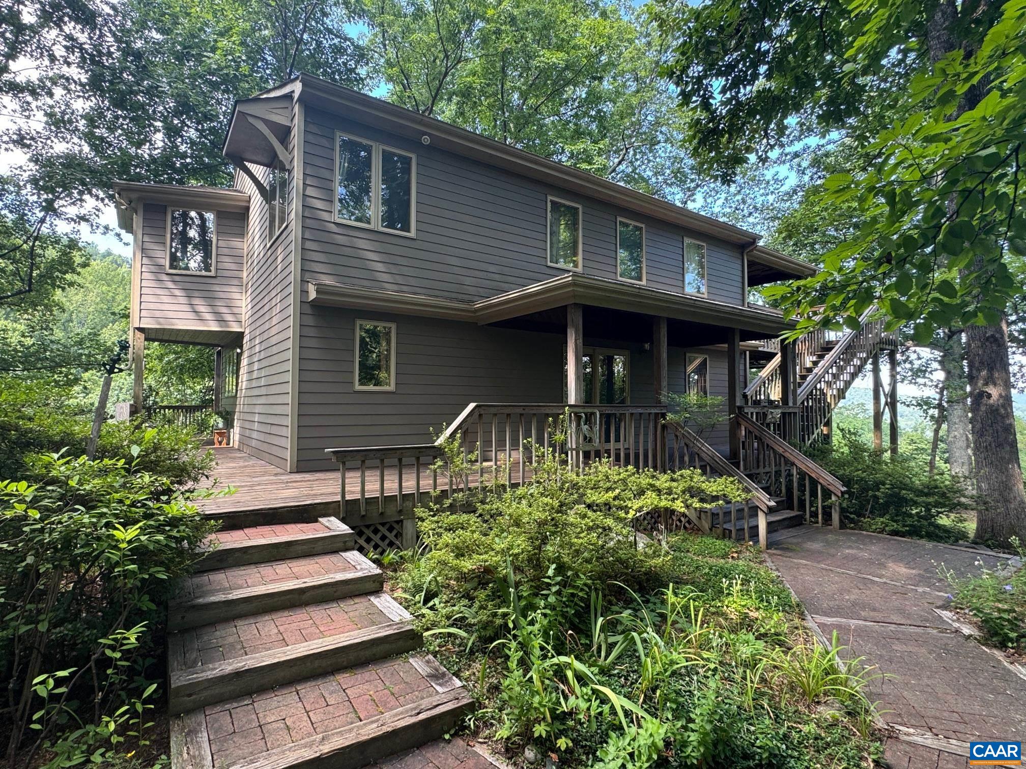 1950 Locust Hollow Road Charlottesville, VA 22903 - Photo 3 of 54 a front view of a house with a yard