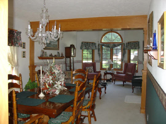 233 Rochester Road Northeast Poplar Grove, IL 61065 - Photo 4 of 11 a view of a dining room with furniture and chandelier