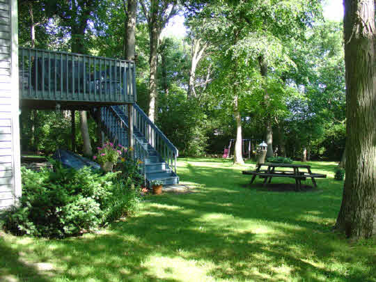 233 Rochester Road Northeast Poplar Grove, IL 61065 - Photo 10 of 11 a view of a park with large trees and a wooden fence
