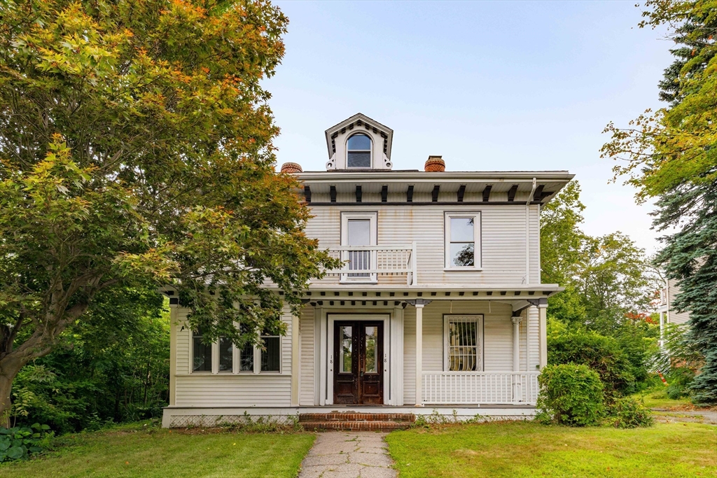 a front view of a house with a garden