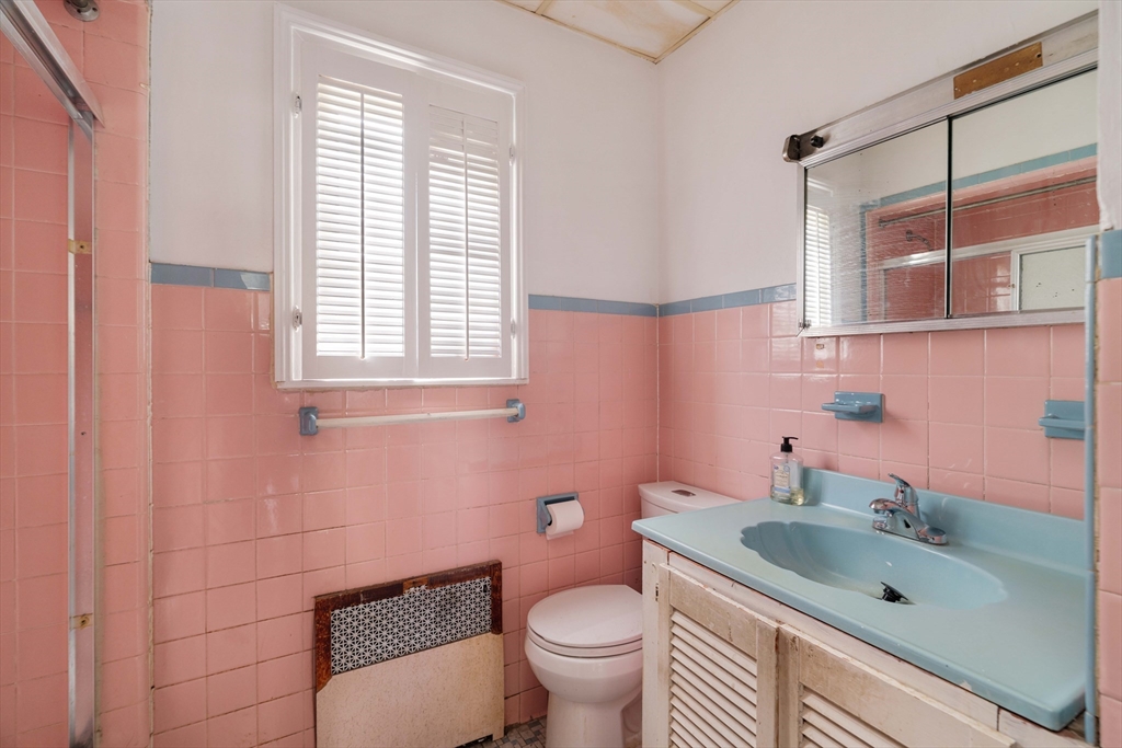 18 Westminster Avenue Boston, MA 02119 - Photo 24 of 37 a bathroom with a sink a toilet and shower